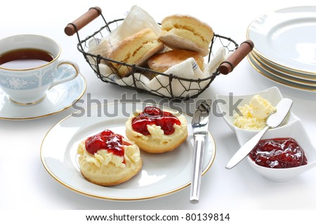 scone with strawberry jam and clotted cream , afternoon tea break , cream tea , tea party , buttermilk biscuits