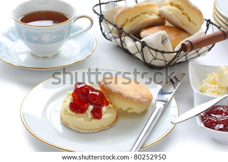 scone with strawberry jam and clotted cream , cream tea , devonshire tea , tea party , afternoon tea , buttermilk biscuits