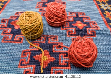 Balls of wool over knitting homemade carpet