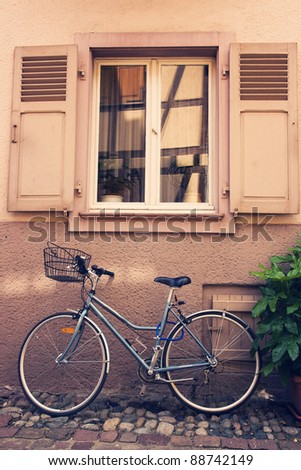 Bike parked under a window, cross process