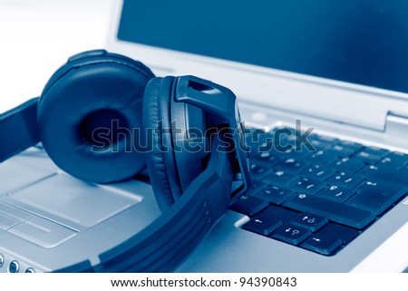 Headphones on Laptop, blue toned
