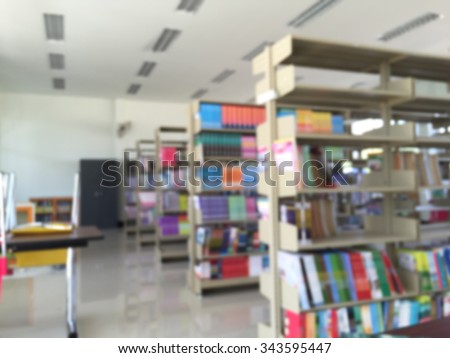 Books on bookshelf in library, abstract blur background