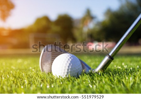 Golf club and ball hit swing shot on course in the summer