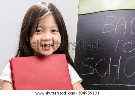 Little Girl Holding Book / Little Girl Holding Book Background / Little Girl Holding Book with Blackboard Aside