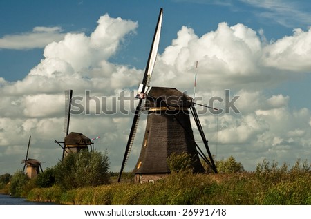 Kinderdijk windmill in a canal in Holland, the Netherlands. Public structure. Listed in UNESCO World Heritage List.