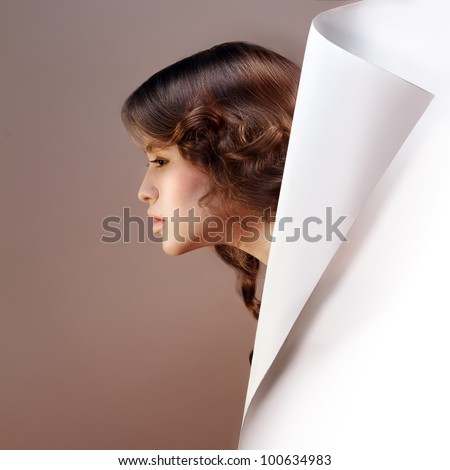 Design element template. Portrait of beautiful girl made in profile hiding behind of paper corner