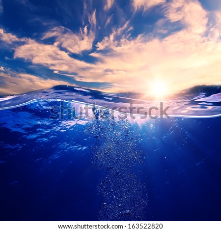 Tropical postcard sea water design template. Beautiful sunset at the sea nice pink clouds and blue water with air bubbles