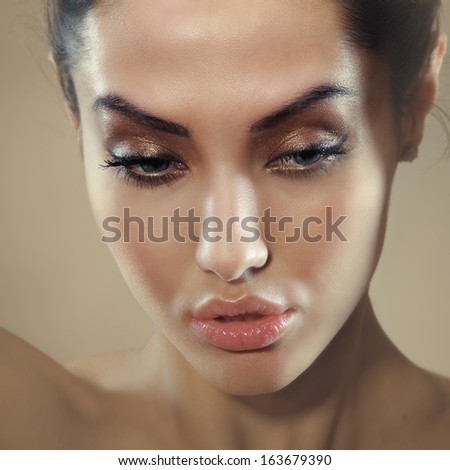 square image closeup of young beautiful female face with sensual lips looking down