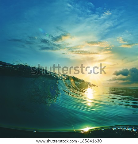 Ocean-view design postcard. Beautiful colorful breaking surfing ocean wave rushing at sunset time