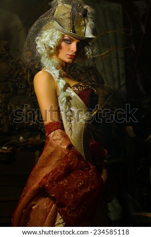 Creative retro portrait of blonde woman wearing hat in wild west style