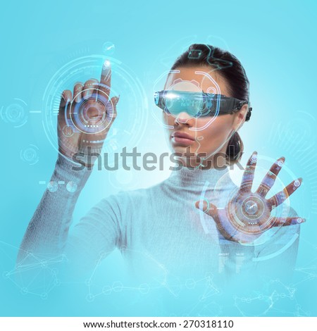 Future technology Virtual Holographic interface. Hi-tech Girl touching screen. Business Young lady working with virtual Graphics in futuristic office.