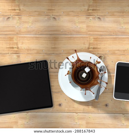 Tablet and smartphone on wooden table and two cubes of sugar falling into a coffee cup