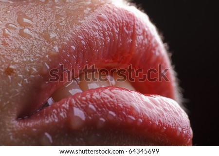 slightly opened wet female lips with water drops on it