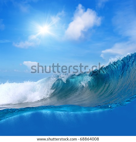 ocean-view seascape landscape Big surfing ocean wave with slightly cloudy sky and the sun