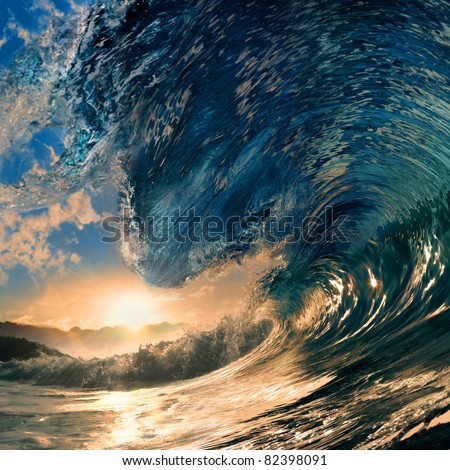 rough colored ocean wave breaking down at sunset time