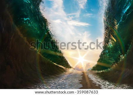 Big waves. Sea parted by a sandy path to the sun with footsteps print on sand