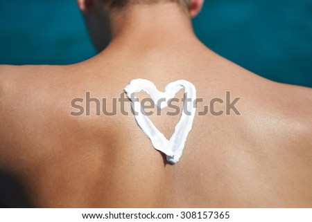 Suntan Lotion At The Beach In Form Of The heart
