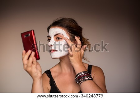 Relaxed woman with a deep cleansing nourishing face mask applied to her face, beauty and skincare concept