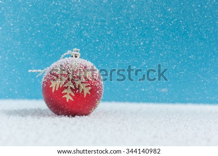 Christmas balls on snow, falling snow