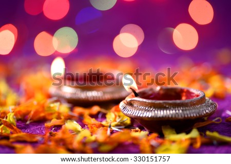 Clay diya lamps lit during Diwali Celebration. Greetings Card Design Indian Hindu Light Festival called Diwali.