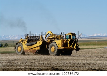 Earth movers in field