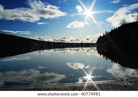Lake view with sun reflection and silhouette