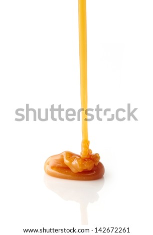pouring sweet caramel sauce on a white background pouring sweet caramel sauce on a white background