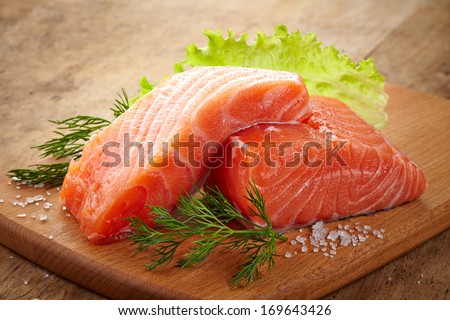 fresh raw salmon on wooden cutting board