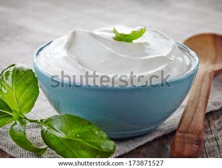 bowl of sour cream and basil leaf
