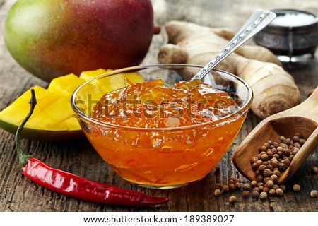 Bowl of Mango Chutney on wooden table