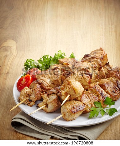 grilled pork meat kebab on wooden skewers