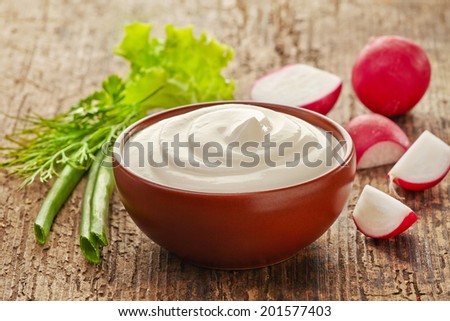bowl of sour cream and fresh vegetables