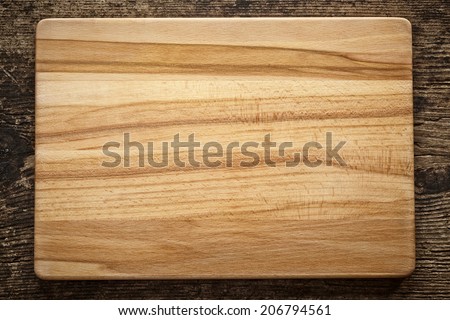 top view of wooden cutting board on old wooden table