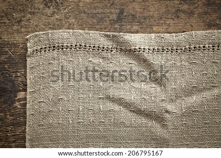 old gray linen napkin on wooden table
