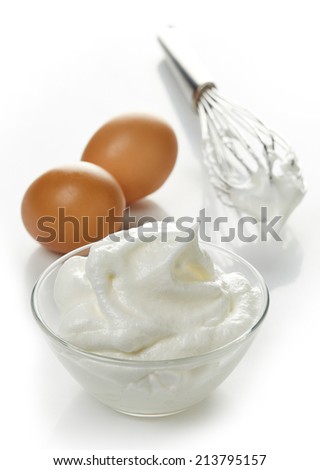 bowl of beaten egg whites isolated on white