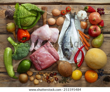 Various Paleo diet products on wooden table, top view