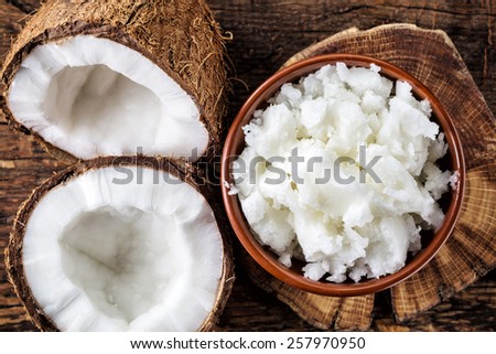 bowl of coconut oil and fresh coconuts, top view
