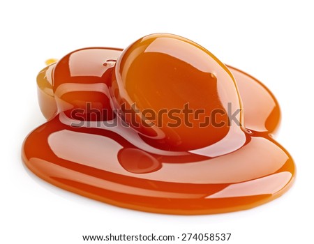 caramel candies and sweet sauce isolated on white background caramel candies and sweet sauce isolated on white background