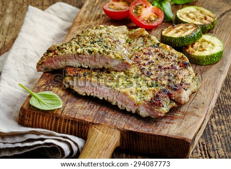 grilled meat and vegetables on wooden cutting board