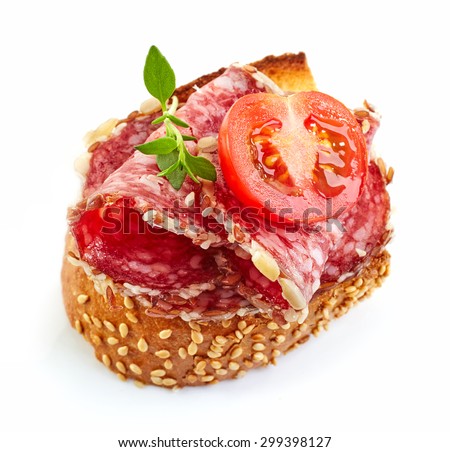 toasted bread slice with salami and tomato isolated on white background