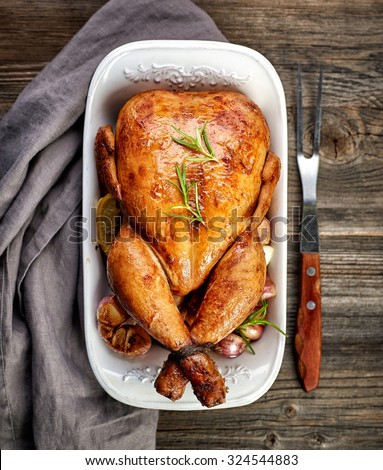 roasted chicken on wooden table, top view