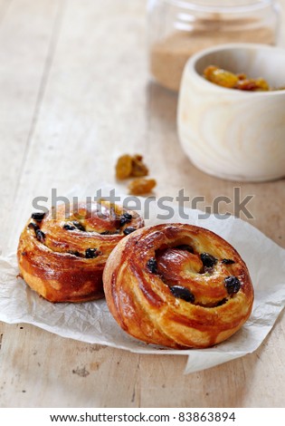 two fresh sweet buns on old wooden table