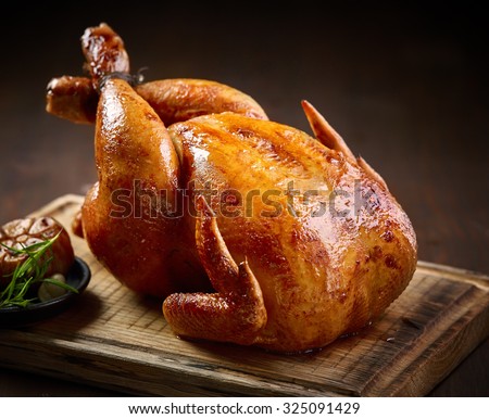 roasted chicken on wooden cutting board