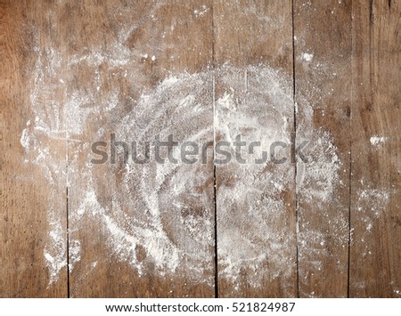 white flour on rustic wooden table, top view
