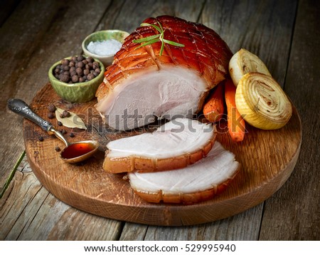 roasted pork on rustic wooden cutting board, top view
