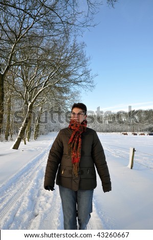 Senior keeping fit in winter time by walking in the snow