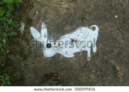 A white stenciled rabbit with a button eye.