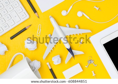 Travel Planning. Airplane, smart phone, pencil, paper note, paper clip, earphone, calculator with blank space. Preparation for Traveling and Flat lay Concept.