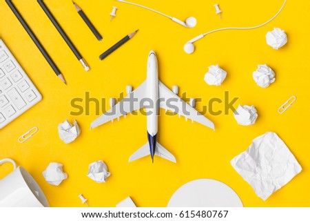 Travel Planning. Airplane, pencil, paper note, paper cilp, earphone, calculator with blank space. Preparation for Traveling and Flat lay Concept.