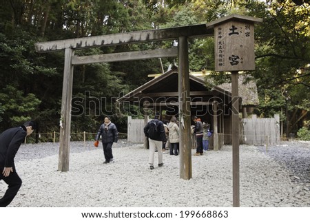ISE, JAPAN- December 29, 2013: Japanese people bow and enter the sanctuary of Tsuchi-no-miya, one of the spirits worshiped at Ise Jingu as part of the Shinto religion.